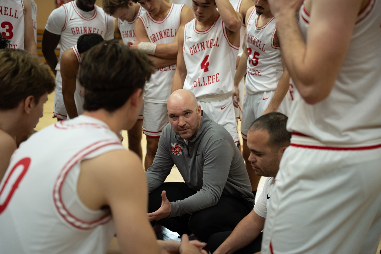 Coach David Arsenault Jr. talks to the team at Grinnell's home opener game against Principia College on Saturday, Nov. 16, 2024. 