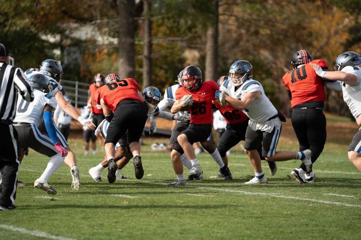 Sam Eaton (26) pushes through avoiding defense during a game against Illinois College at Rosenbloom Field on Saturday, Nov. 11, 2024. (Marc Duebener)