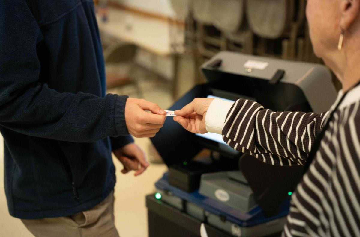 Jack Broadmoore, 20, receives an "I Voted" sticker after casting his ballot at Elks Lodge in Grinnell, Iowa on Nov. 5, 2024.