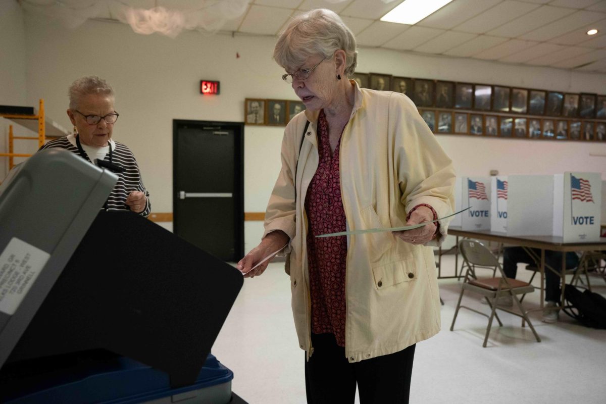 Kay Balleau, 76, casts her ballot into the machine at Elks Lodge in Grinnell, Iowa on Nov. 5, 2024.