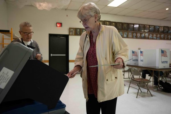 Kay Balleau, 76, casts her ballot into the machine at Elks Lodge in Grinnell, Iowa on Nov. 5, 2024.