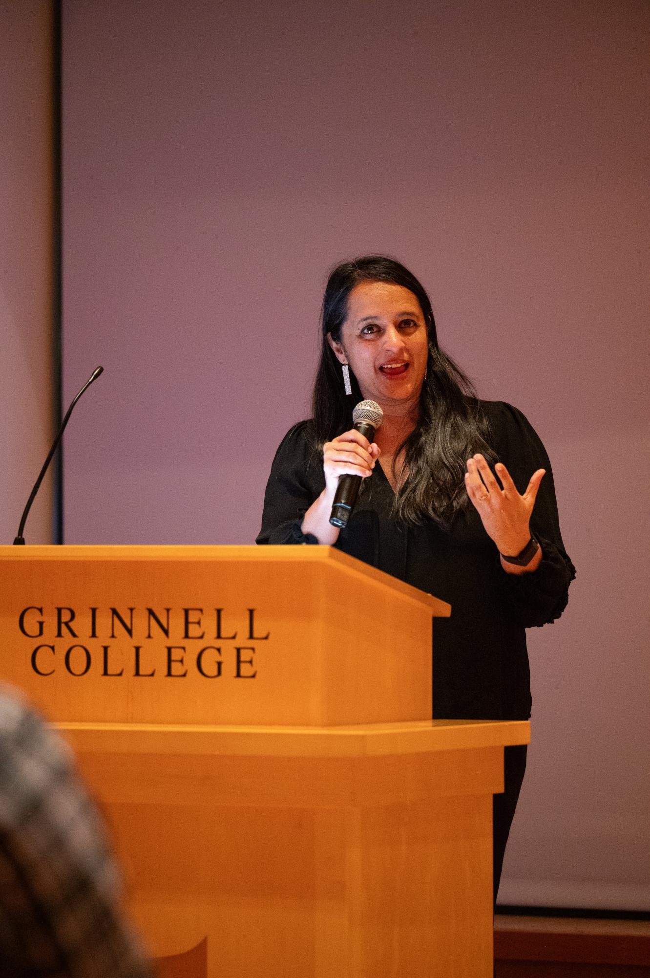 Reena Esmail smiles mid-lecture.