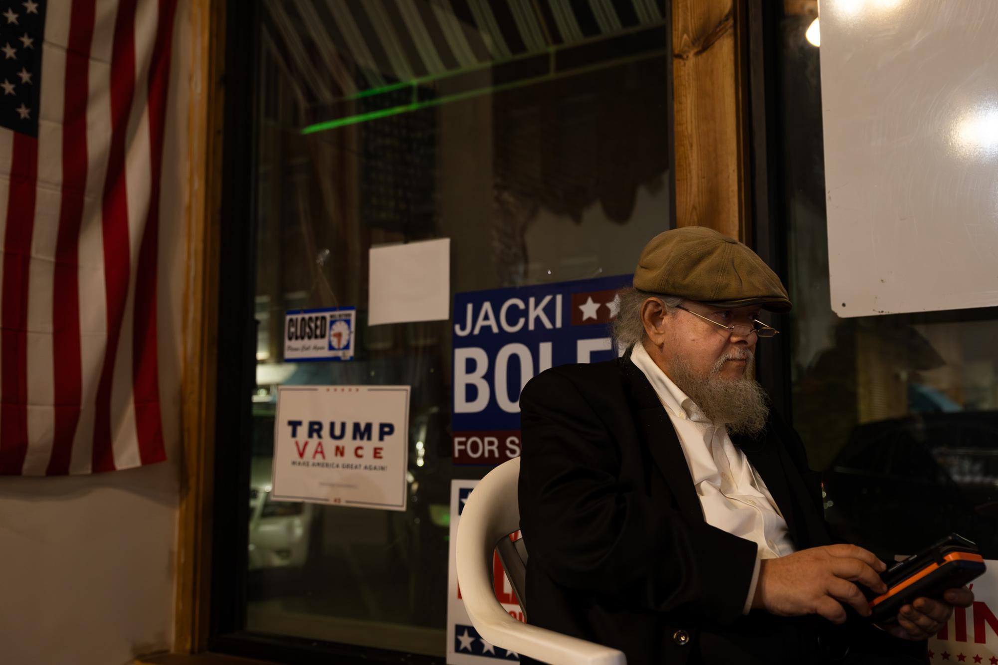 Jerome Scheuring watches election results come in at the Poweshiek County Republican Party headquarters in Grinnell, Iowa on Nov. 5, 2024.