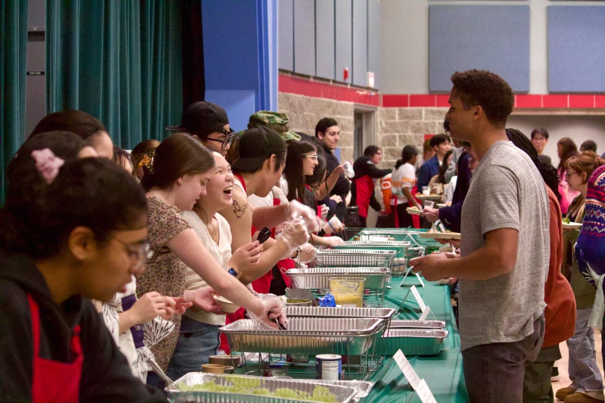 Students serve food at the food bazaar.