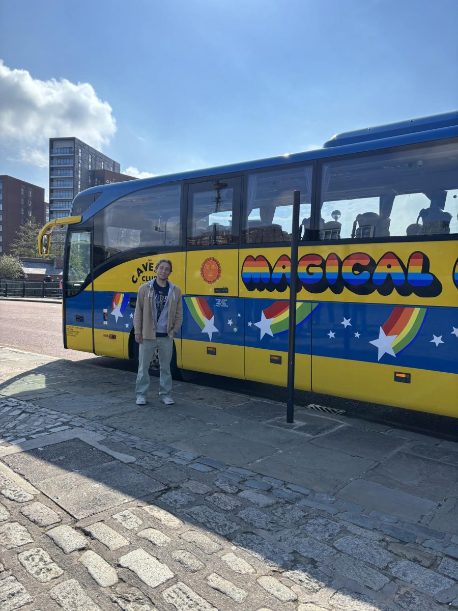 Oliver Wolfe `25 poses outside the Beatles Magical Mystery Tour bus in Liverpool.