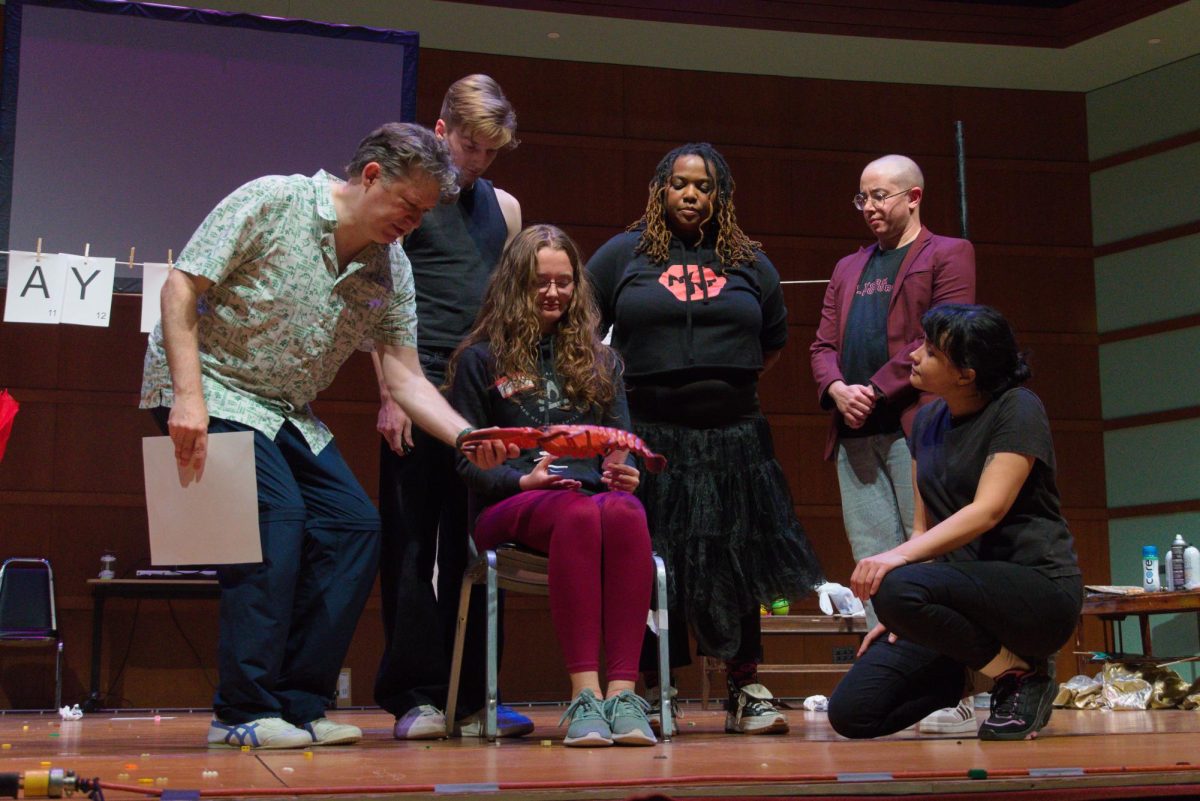 (Left to right) Rob Neill `91, Jake Banasiewicz, Kyra Sims, Lee Lebreton and Robin Virginie participate in a play with a student at Sebring-Lewis Hall on November 1.