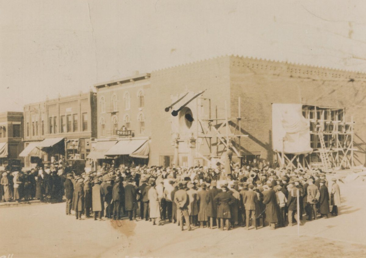 A crowd gathers to view the installation of the stained glass windows at Merchant's National Bank in Grinnell, Iowa, in 1914. Archival image from Digital Grinnell.