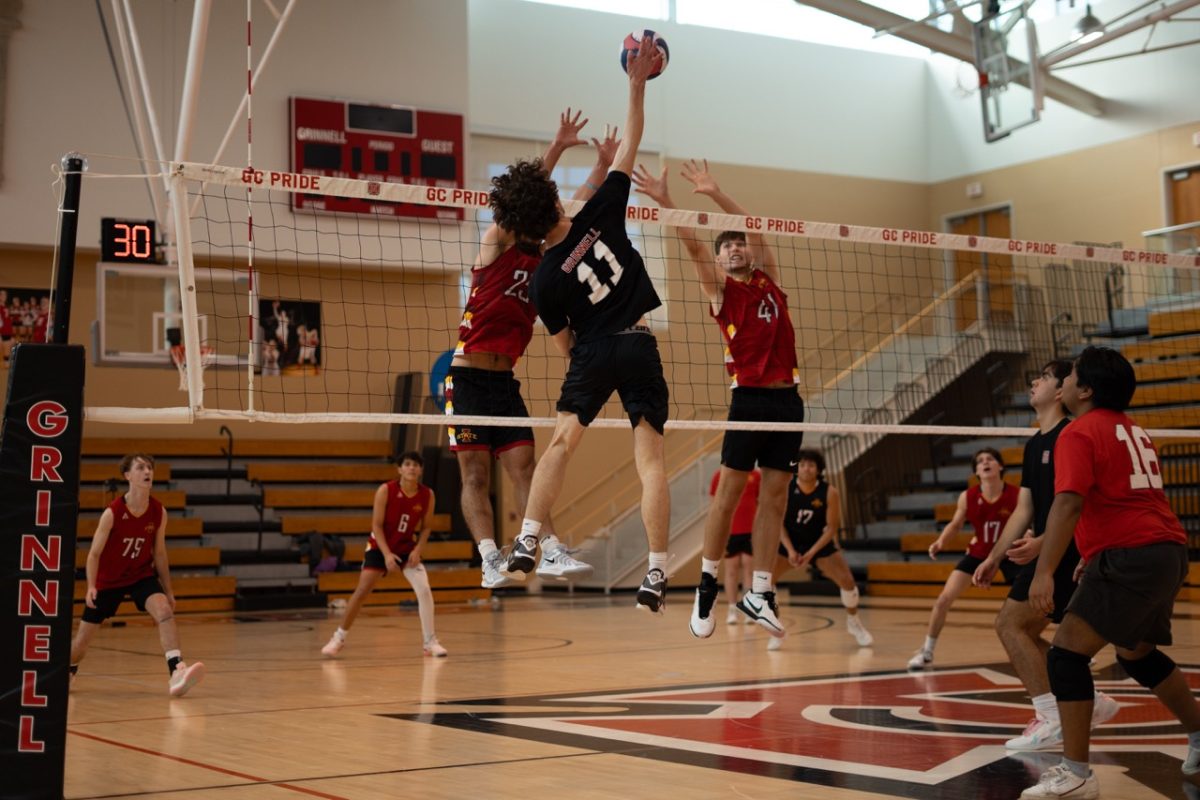 Matt Kenny (11) spikes the ball past defenders during a game against Iowa State on Nov. 10, 2024.