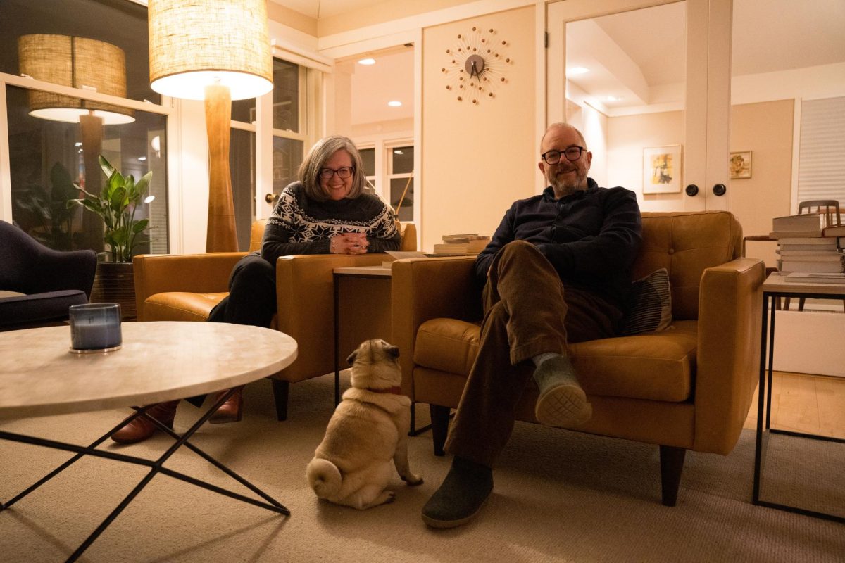 From left: President Anne Harris, their dog May, and Professor Michael Mackenzie at their home.