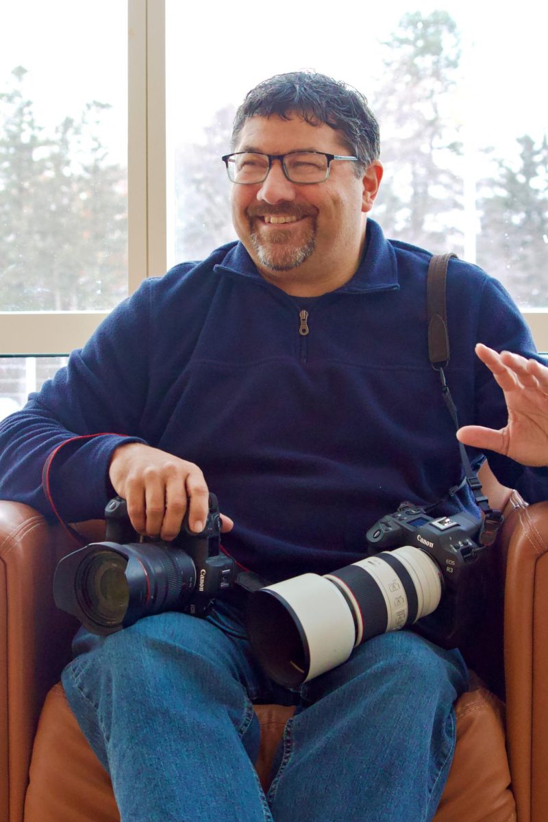 Justin Hayworth posing with his cameras in the Bear. 