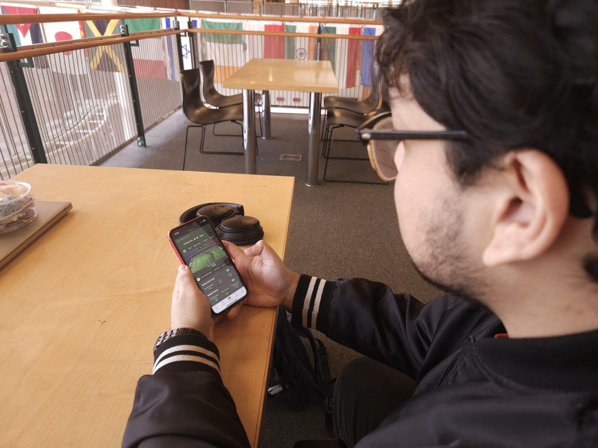 Yahir Dominguez follows live updates of games through a sports betting app. 