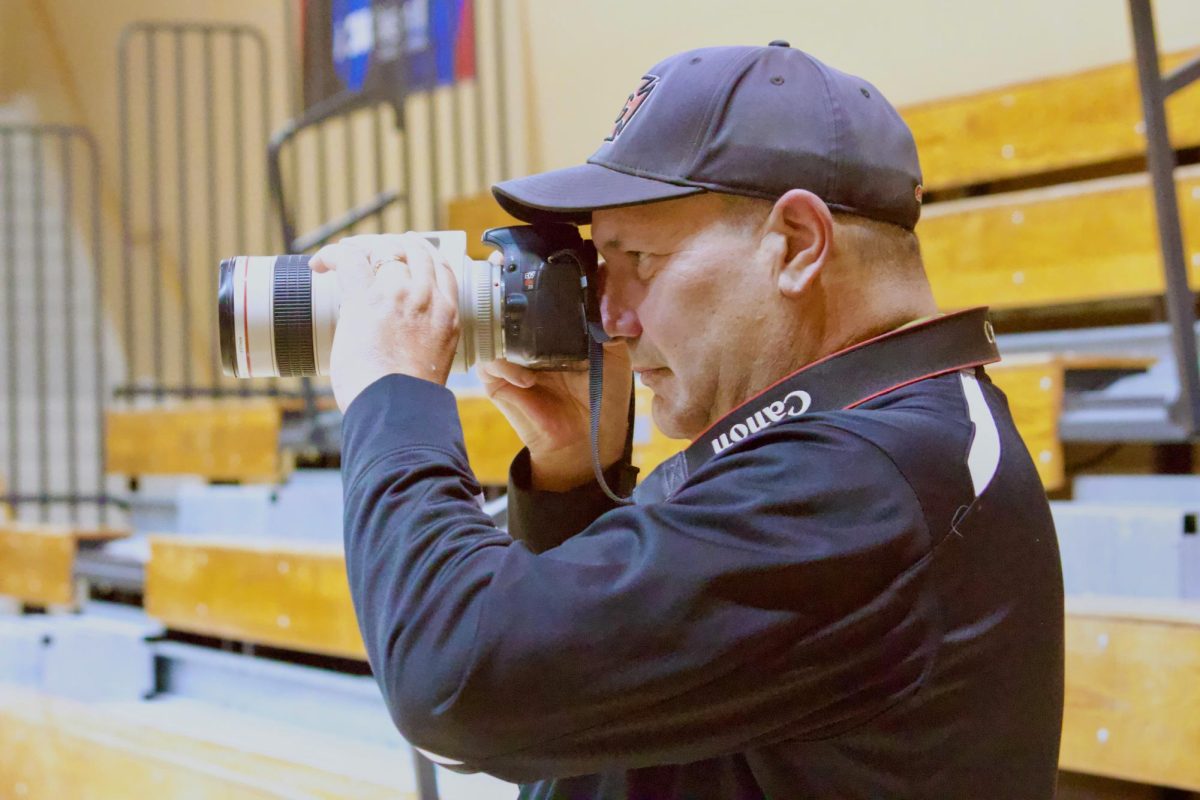 Ted Schultz captures photos in Darby Gymnasium.