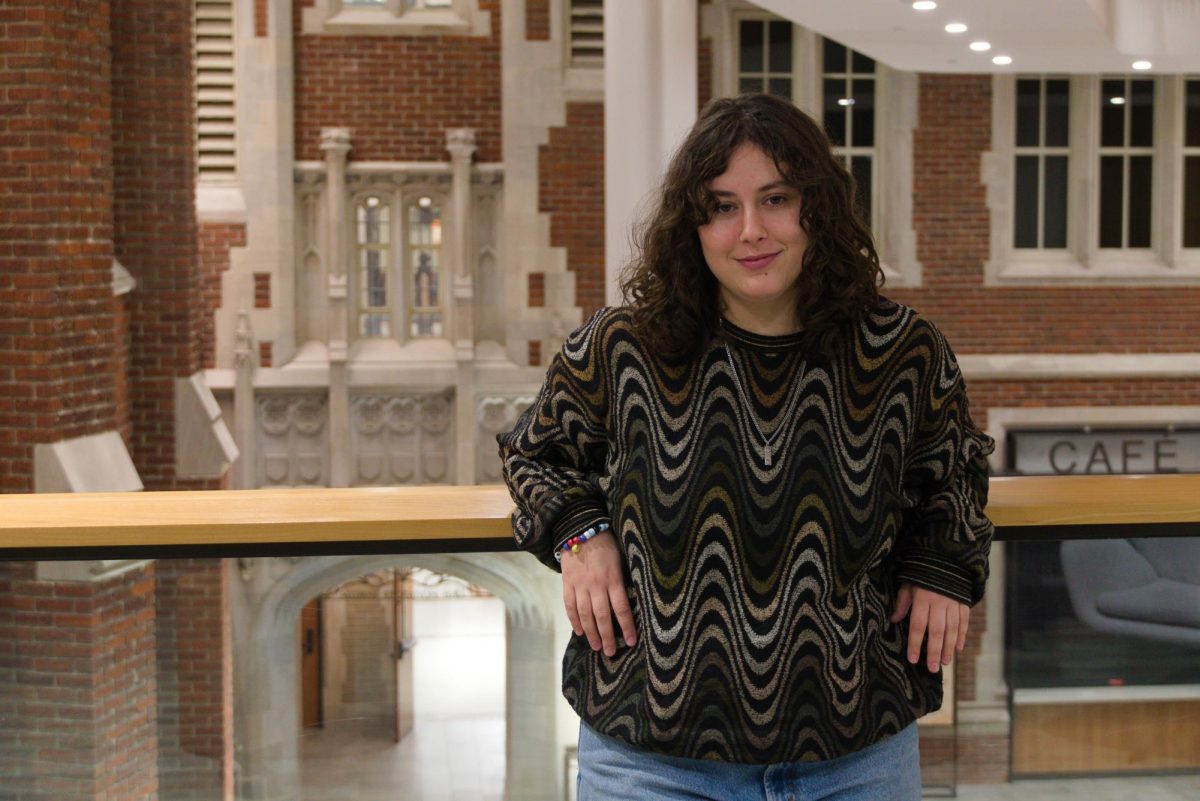 Zev Zentner `25 poses on the bridge of the Humanities and Social Sciences Center (HSSC).