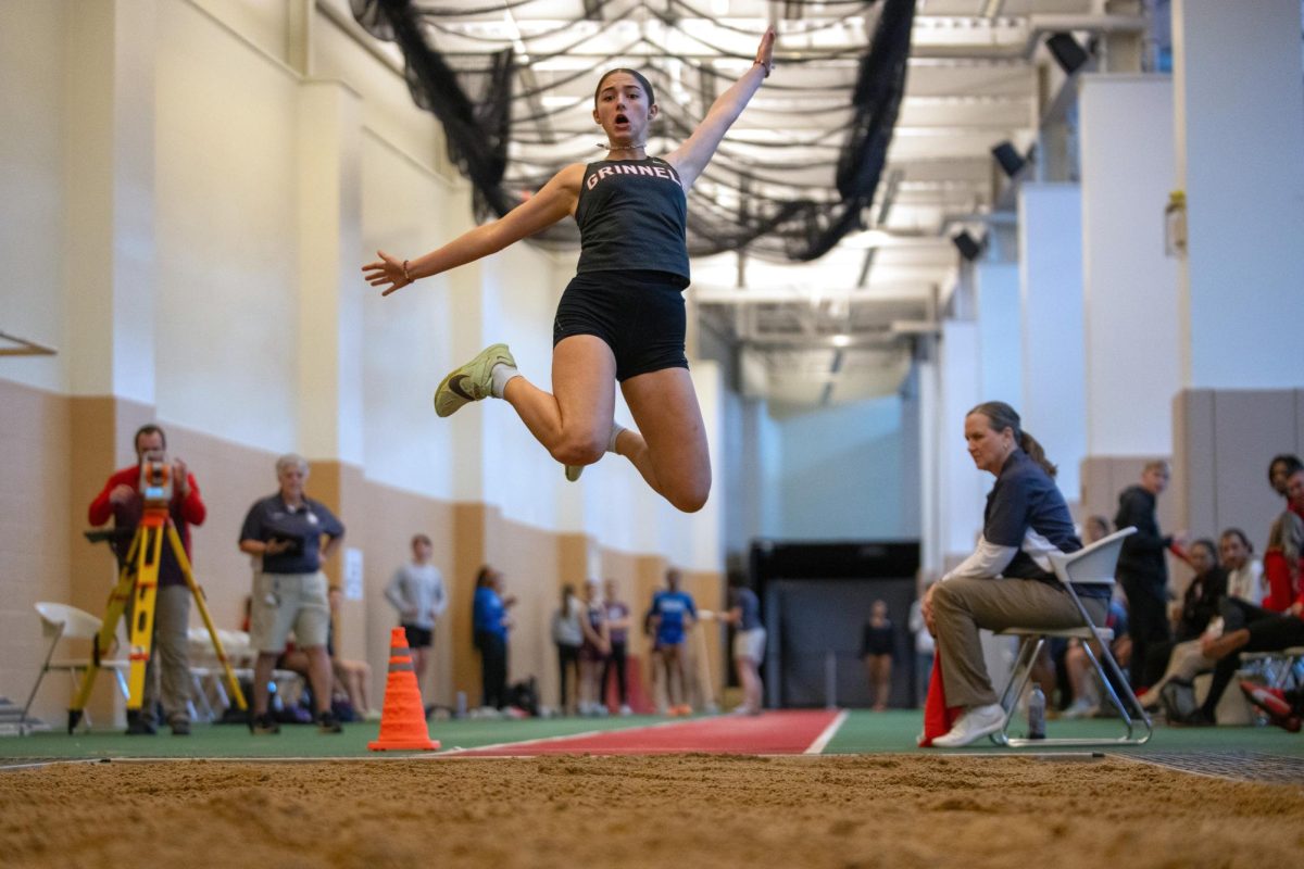 Lily Mayo '25 leaps to 2nd place in the long jump at the Grinnell Invitational on Saturday, Feb. 1, 2025.