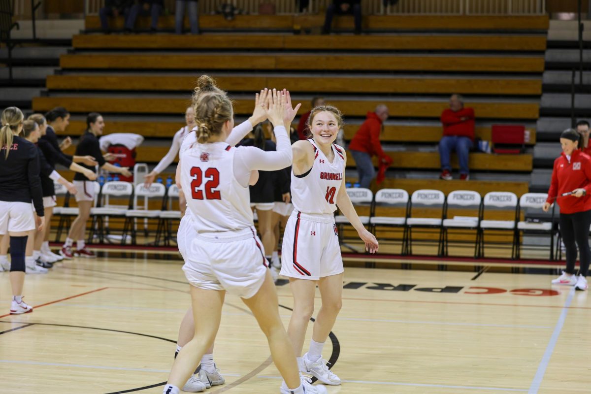 Nikki Ware (10) high fives teammate Skylar Thomas (22) before tip off.