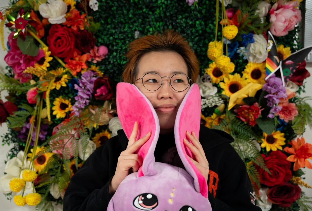 Chikako Inoue `26 poses with a stuffed toy in the Stonewall Resource Center.