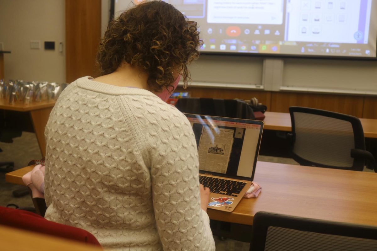 Hayley Carson `25 examines a digital copy of the Iowa Bystander on 
Thursday, Feb. 13.