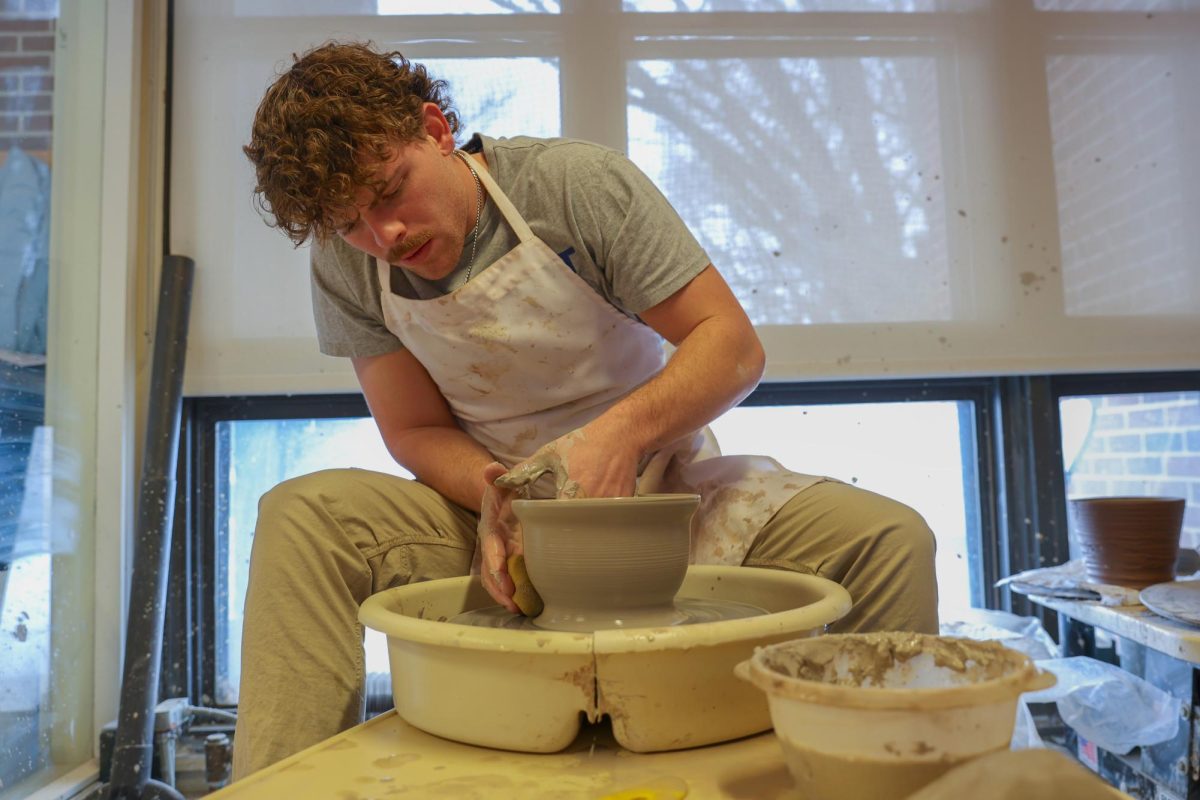 Ethan Crawford '25 carefully pulls up the walls to create a bowl.