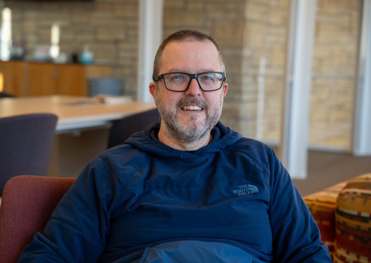 Ryan Solomon, Director of Civic Education and Innovation at the College, poses for a photo in the Center for Careers, Life and Service.