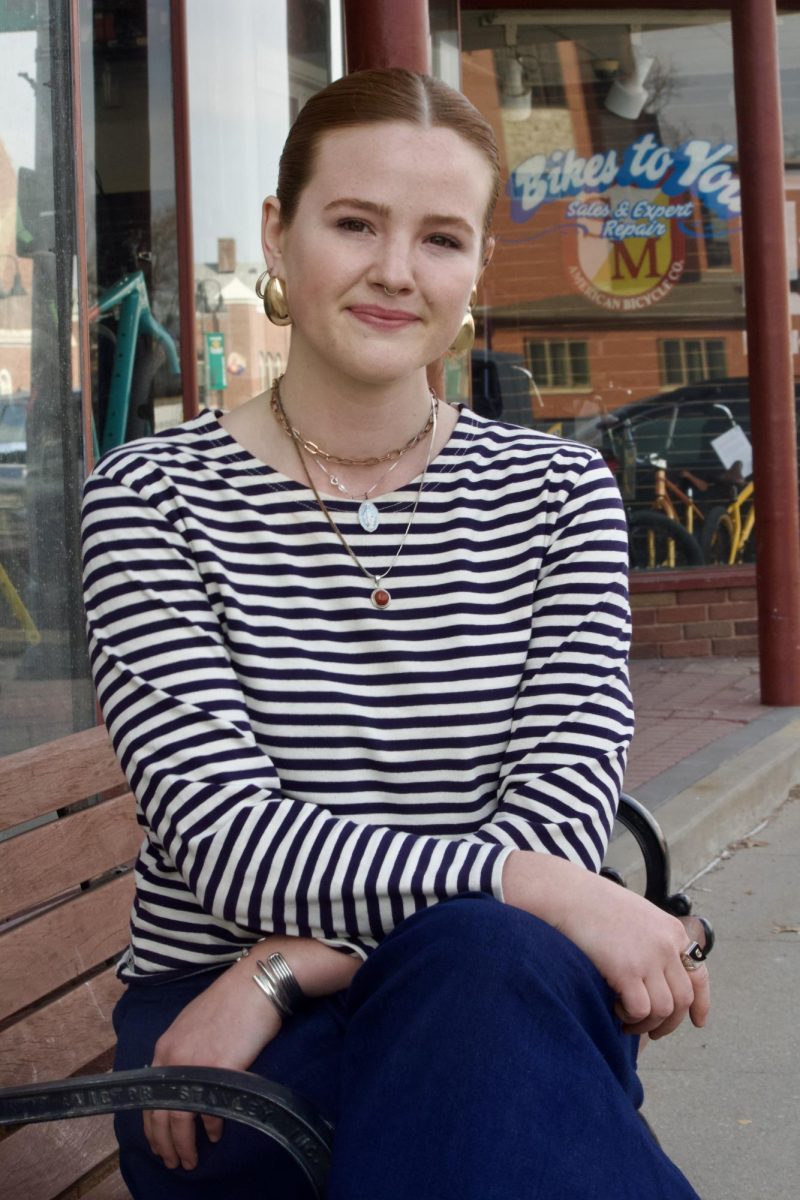 Ren Fisher, 25, former owner of now-closed Poweshiek Trading Post, outside of Saint's Rest Coffeehouse.