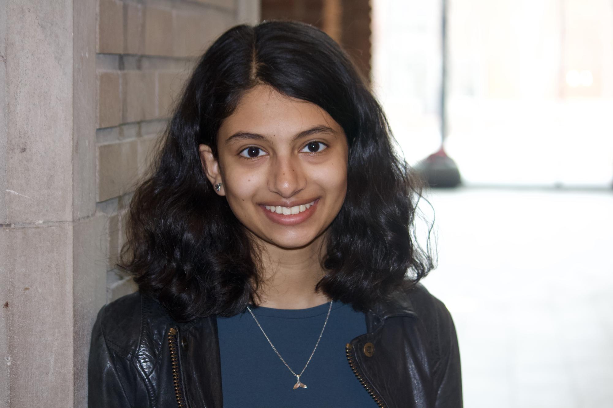 Asha Kulkarni `28 poses in the Humanities and Social Studies Center.