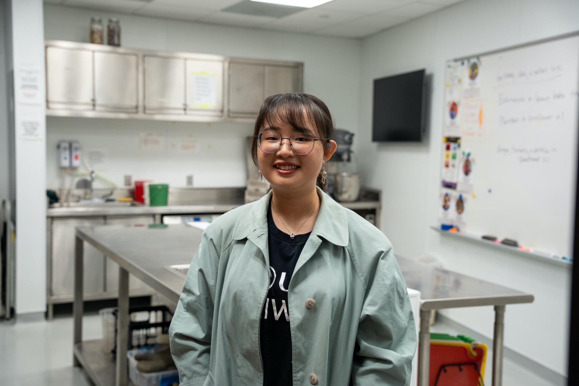 Candice Hui-Chieh Lu `26 poses in the Global Kitchen on April 9, 2025.