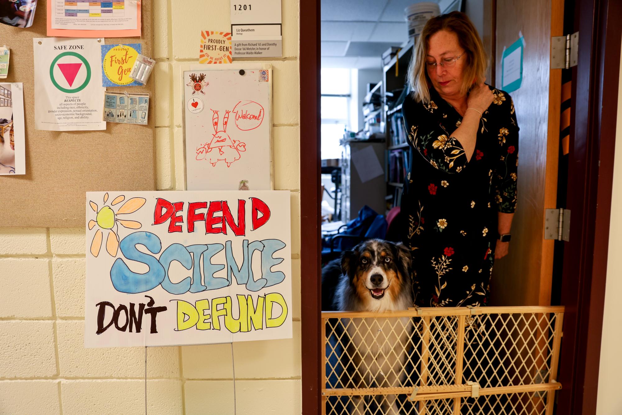 A sign with "Defend Science Don't Defund" written on it can be seen by those walking into the West entrance Noyce Science Center in front of Professor of Biology Liz Queathem's office.

