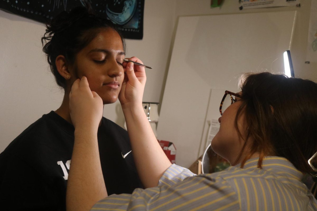 From left: Rama Joshi `27 gets her eyebrows done by Kelly Olson `27. 