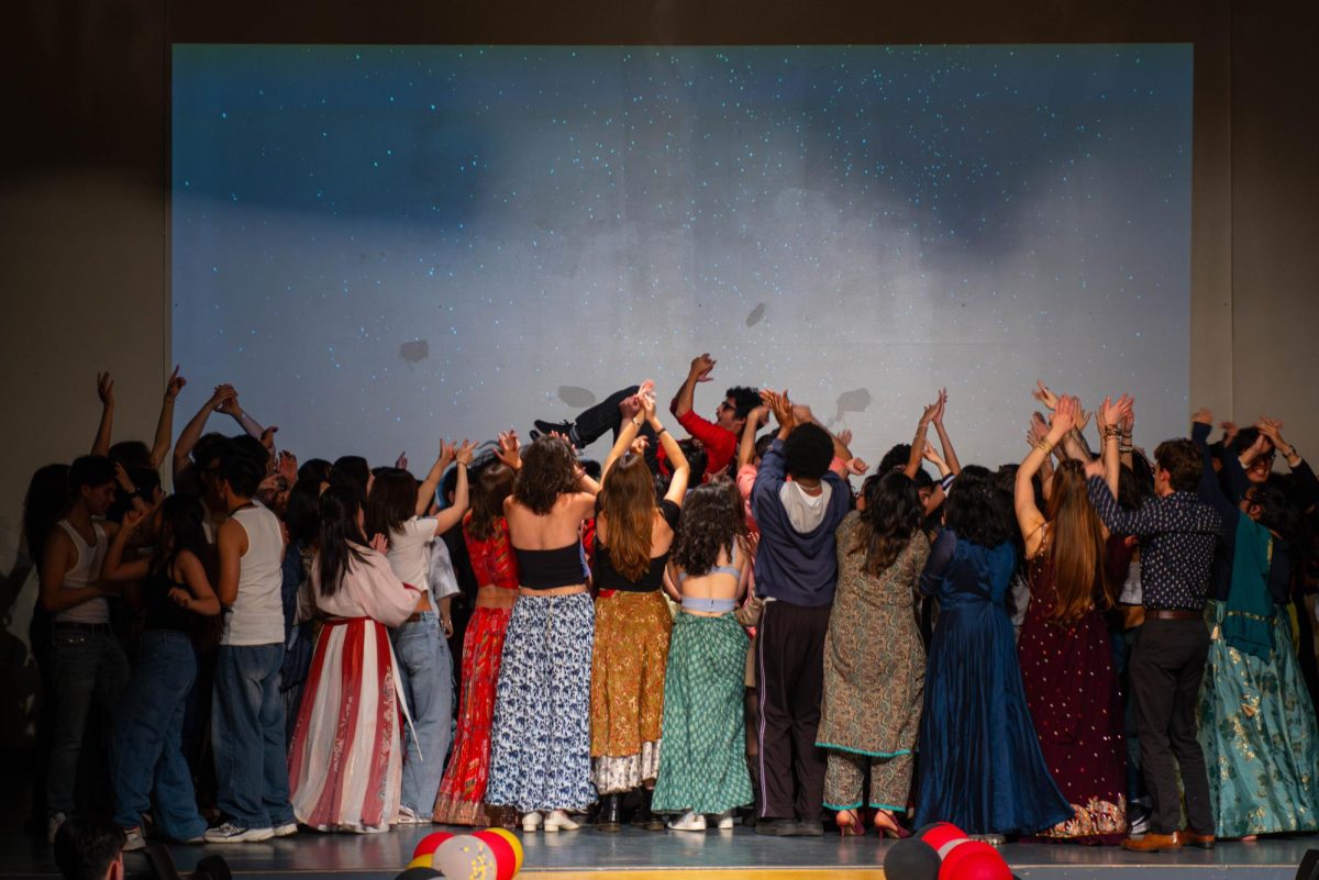 Performers in ISO's Cultural Evening gather on stage for a final performance in the Harris Center on Saturday, April 12.