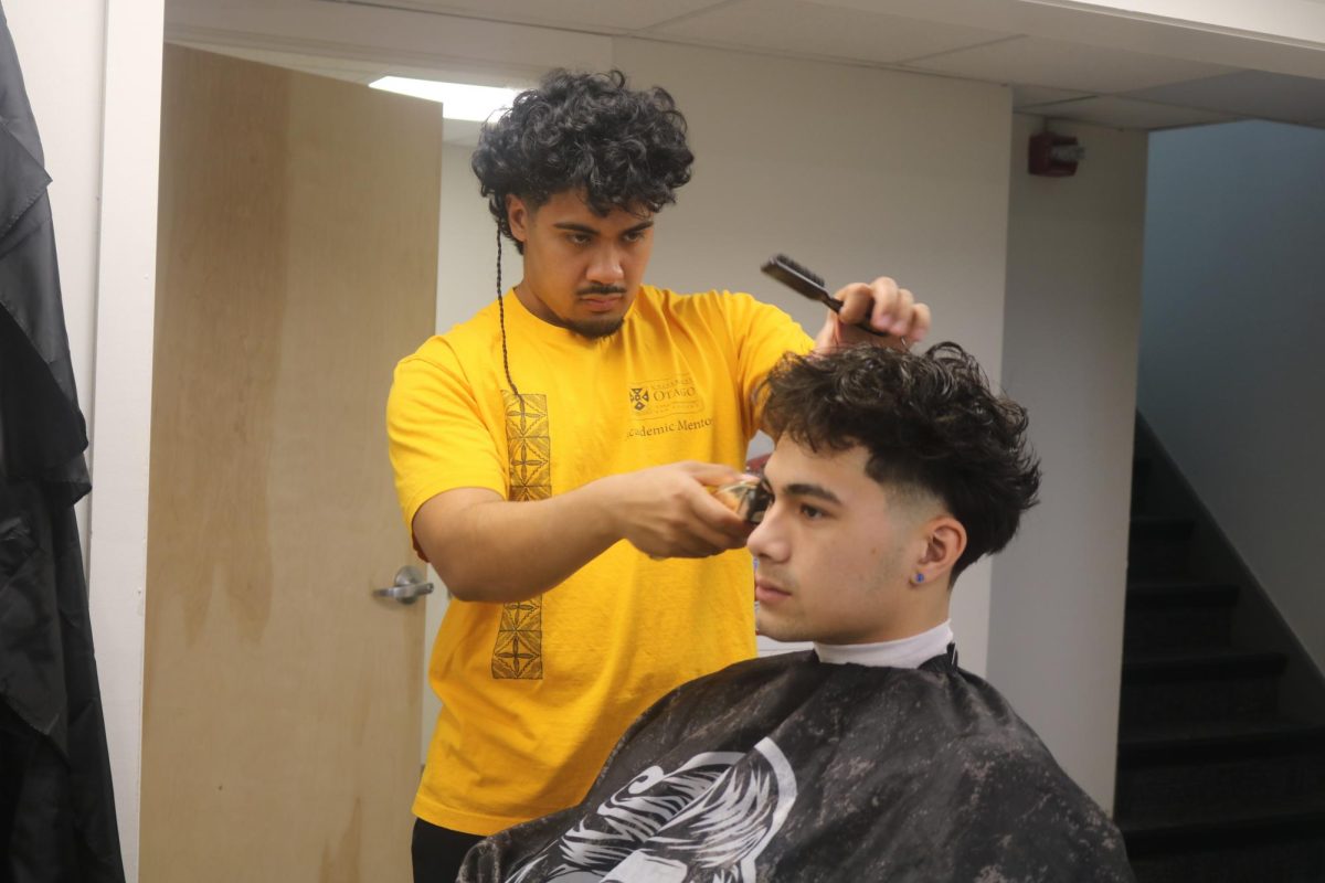 Will Reyes `25 cuts Gabe Garcia's `27 hair in the Black Cultural Center Salon.