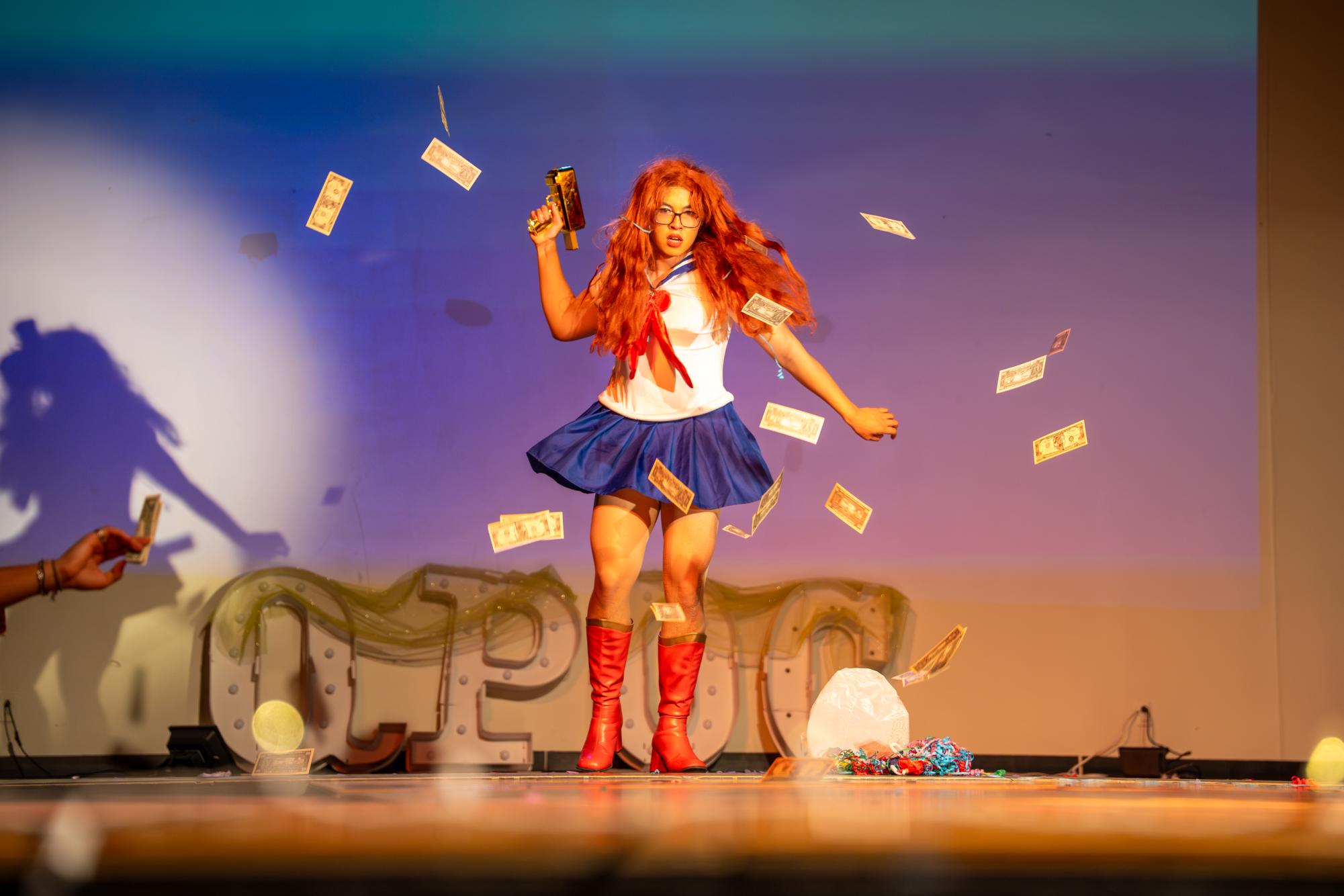 Bitch McConnell makes it rain. All money donated to the drag show will go to the Iowa Trans Mutual Aid Fund (TMAF). 
