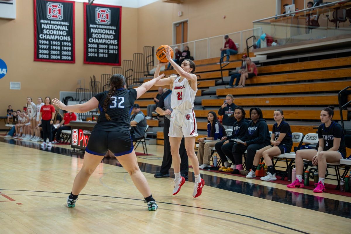 Amelia Rigel ' 28 (21) shoots a three-pointer over a Rockford University defender on Nov. 15.