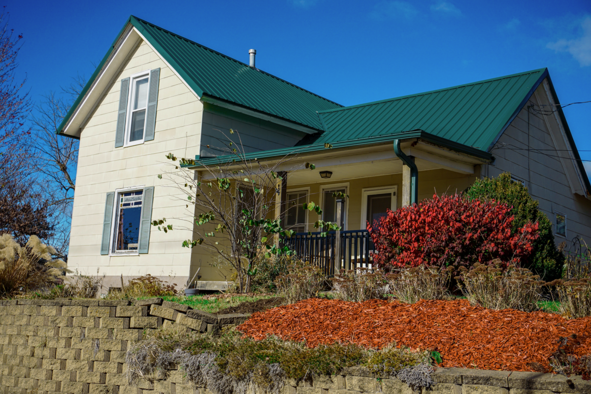 The two-story house, pictured on Nov. 10, 2025, sits atop a gentle rise. While the house has had some updates, such as roof and flooring updates, the windows, which feature colorful stained glass, are original to Edith Renfrow Smith's childhood home.