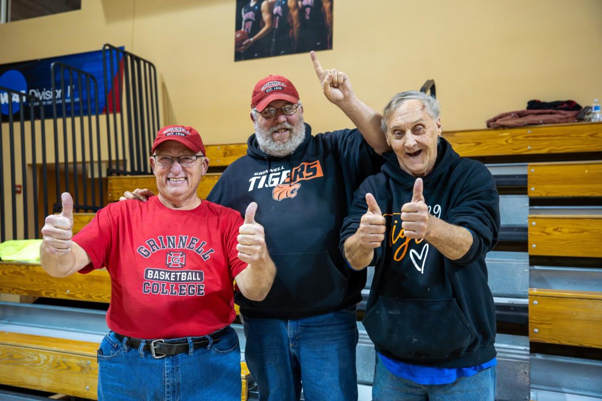 From left: Verl Beck, Jeff Dickinson and Dennis Engelbart, collectively known as “The Stompers,” are some of Grinnell basketball’s most loyal fans.