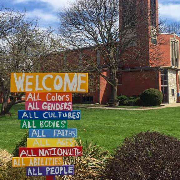 A sign outside of Grinnell United Church of Christ reads "Welcome, all colors, all gender, all cultures, all bodies, all faiths, all ages, all nationalities, all abilities, all people."