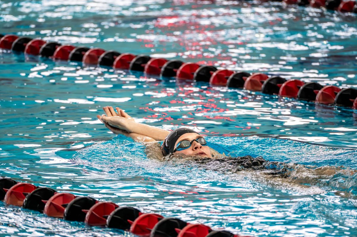 Nina Lyons `29 works on her backstroke at a swim practice in the Natatorium.