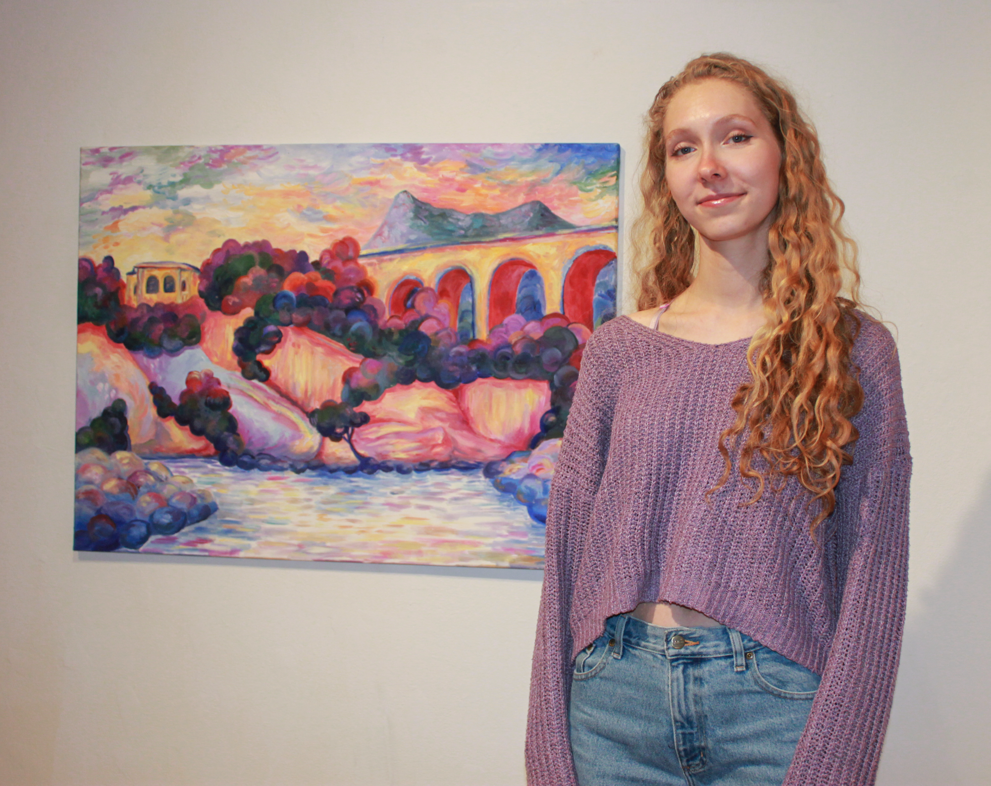 Miriam Vollmayr-Lee `26 stands in front of her 2022 painting “L’Estaque”.