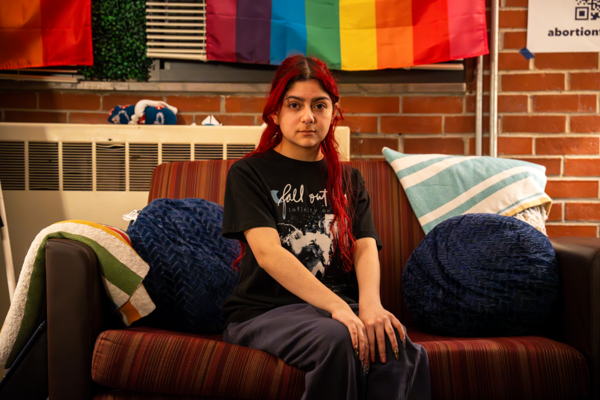 Queer People of Color cabinet member Nicole Rueda `27 poses for a portrait in the Stonewall Resource Center. Rueda said that a larger push into a more conservative Iowa worries them.
