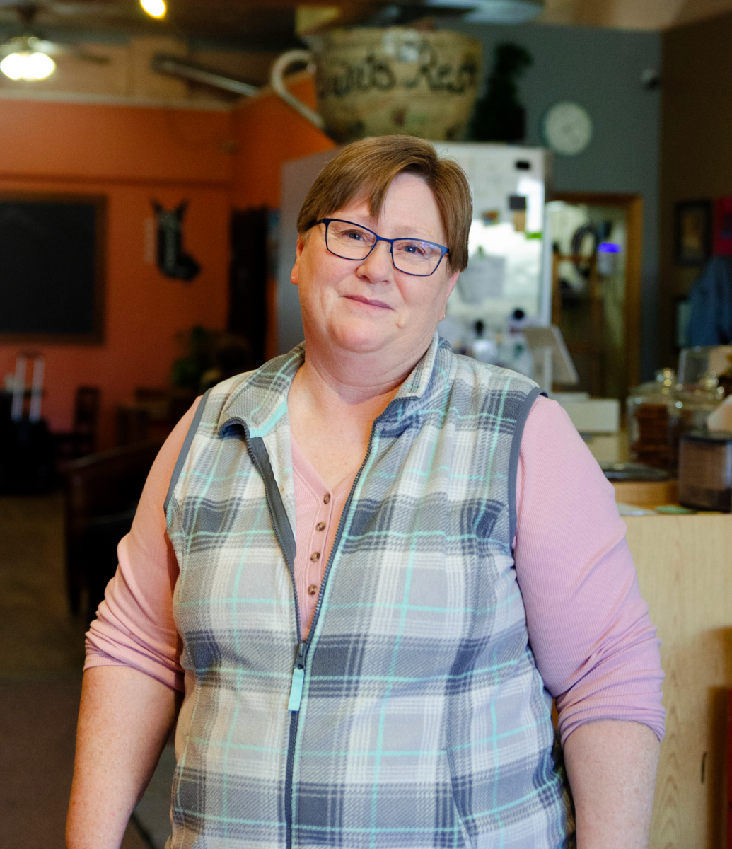 Monique Shore `90, president of PFLAG Grinnell/Poweshiek County, poses for a portrait in Saint’s Rest. Shore said that public displays of allyship can support the LGBTQ+ community.