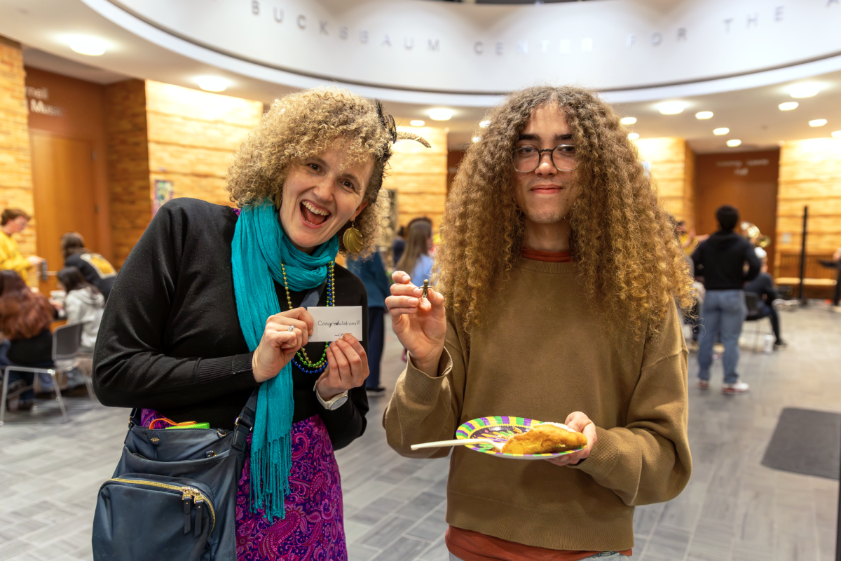 From left: Rev. Cassandra Lawrence and Nicholas Rasmussen `29 pose with the lucky plastic baby found in the king cake at the Mardi Gras event in the
Bucksbaum Rotunda on Tuesday, Feb. 17.