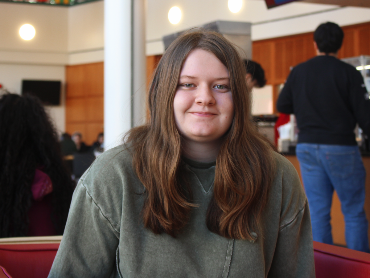 Brynna Schwab `28 poses for a portrait in Spencer Grill. Schwab works at B&B Farms processing chickens.