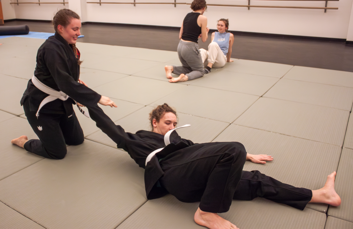 Grace Dukesherer `26 and Henry Mitchell `28 wrestle at the Feb. 16 Brazilian Jiu Jitsu class.