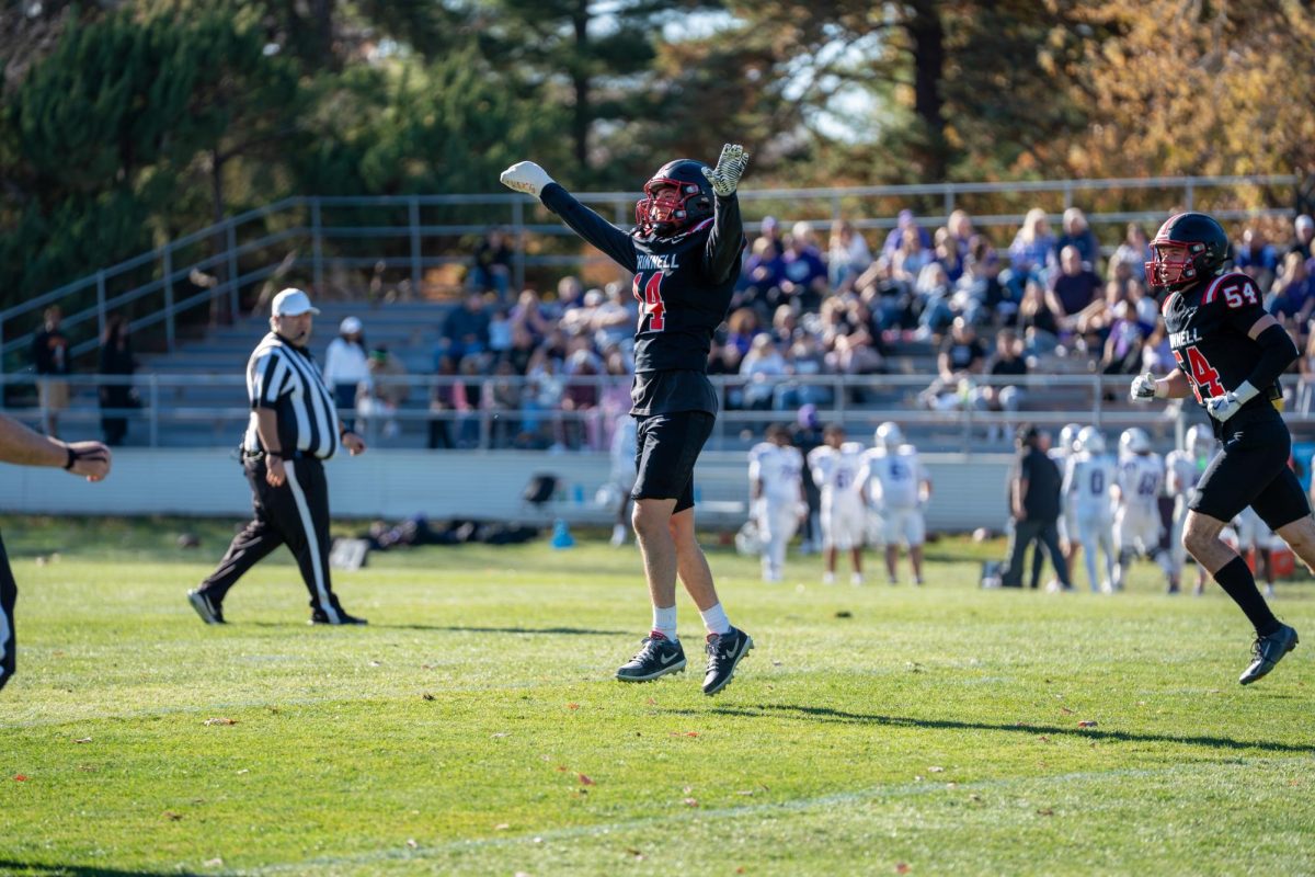 Brandon Tennicott `26 (14) celebrates an incompletion against Cornell College on Nov. 15 with a cast on his right hand.