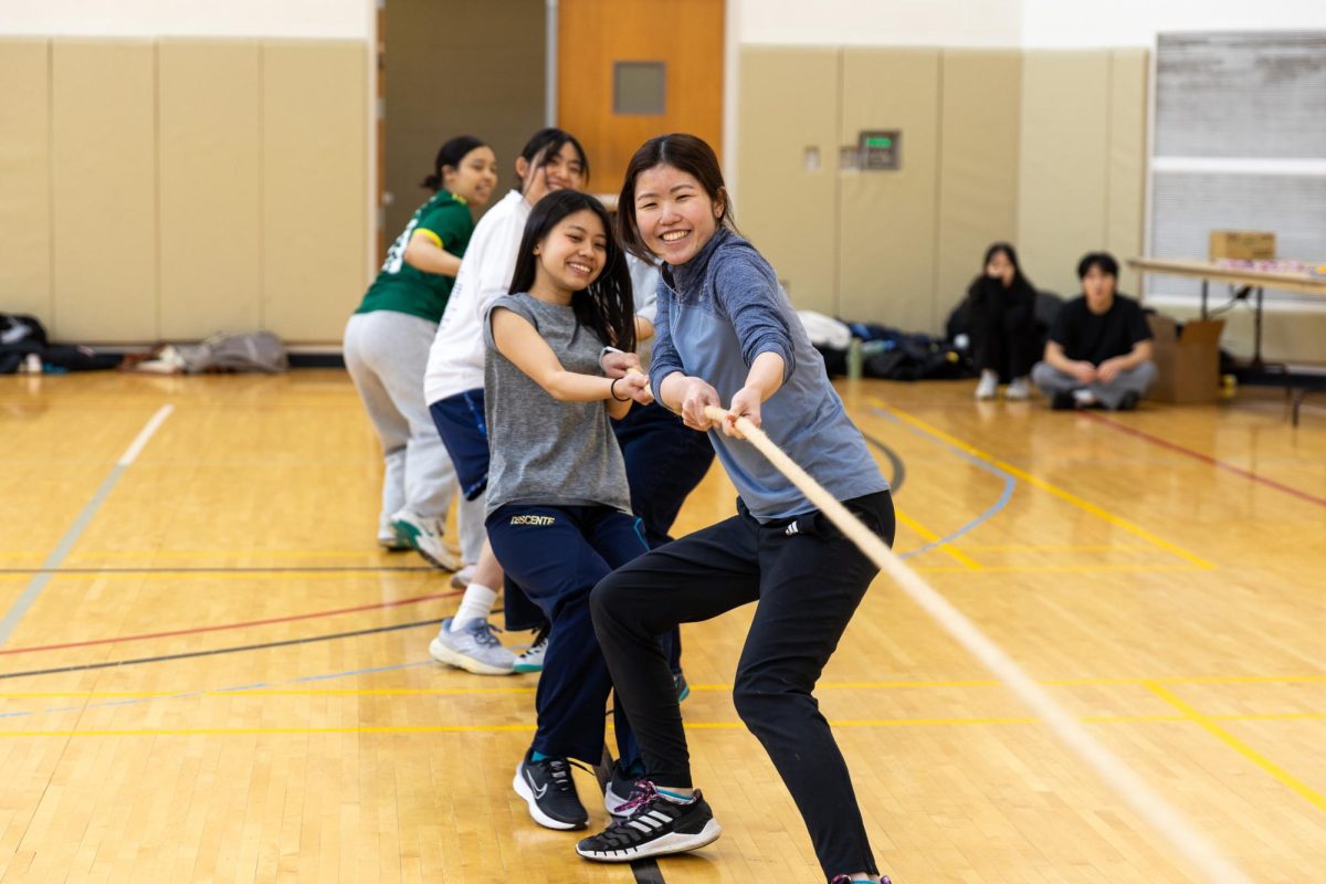 Risa Takemoto `28, front left, and her team pull the rope in a game of Tsunahiki (Tug-of-War) in the Auxiliary Gym during the Japanese Sports Festival on Saturday, Feb. 21.