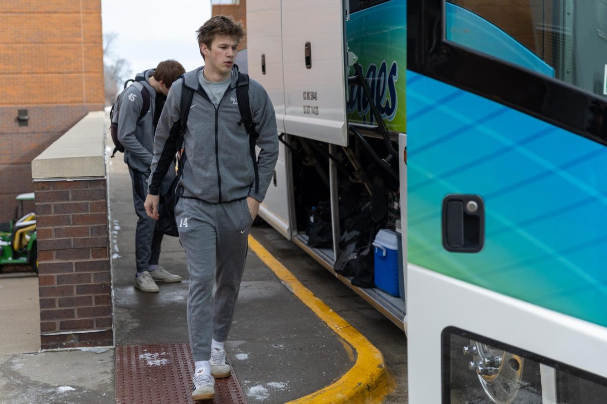 Aidan Wiley `29 (14) boards the bus for an away game against Cornell College on Friday, Feb. 21, 2026.