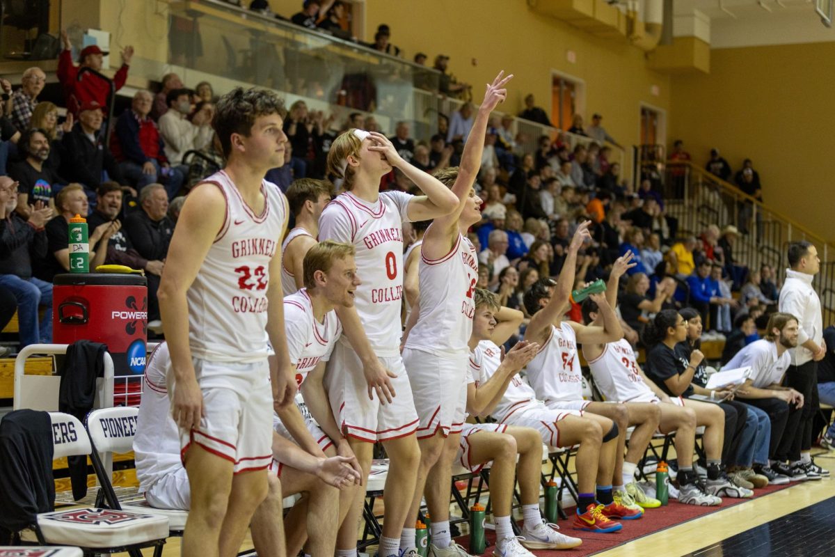 Grinnell's bench celebrates a 3-pointer in the MWC Semifinal game against Illinois College at Darby Gym on Friday, Feb. 27.