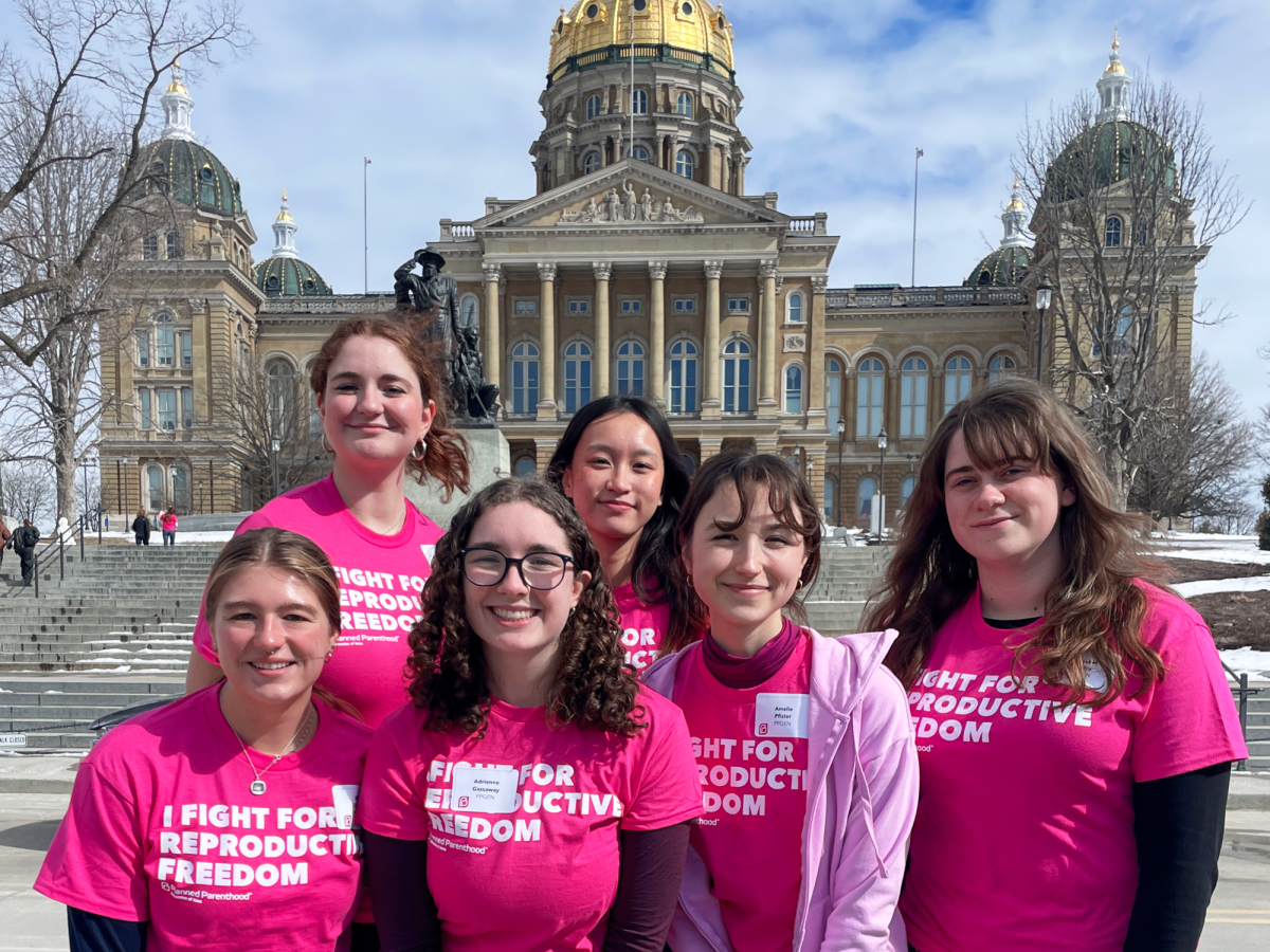 Members of Students for Reproductive Justice pose in front of the Iowa state capitol.