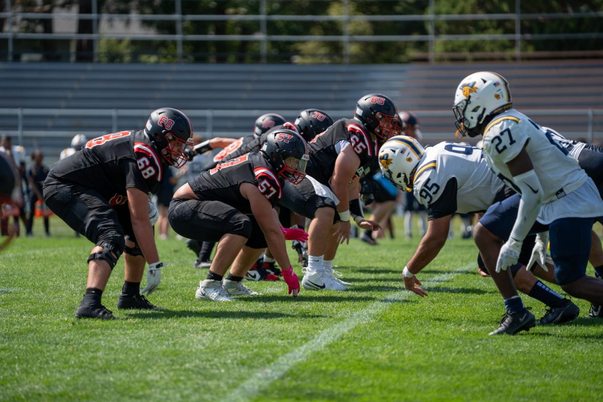 Cash Hardy `28 (57) lines up against Beloit College on Sept. 13, 2025.
