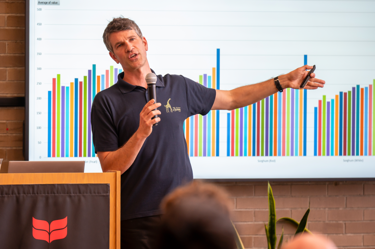 Leif Brottem presents graph to showacse the statistics that he and Parikshit Roychowdhury `28 found in their research of Chad.