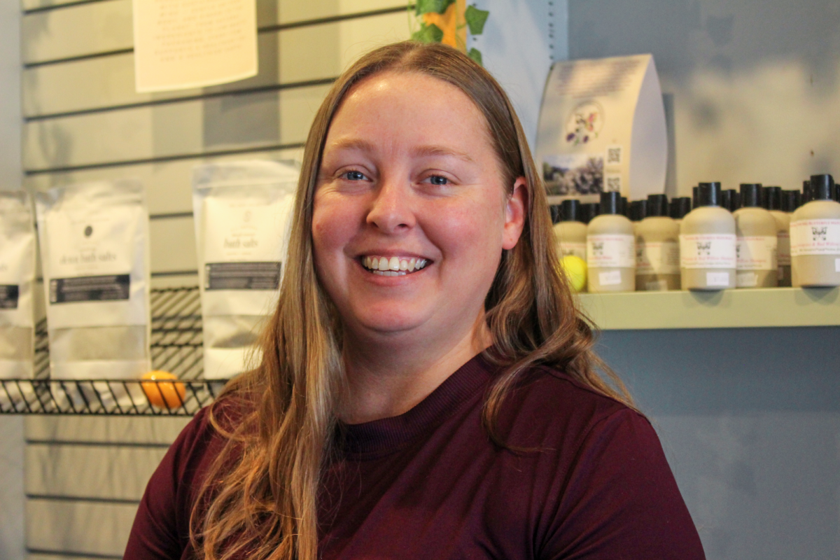 Braden Crist poses in Homeopathic Remedy Apothecary located in Grinnell at 823 4th Ave. W.